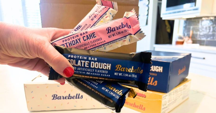 Hand holding several barebell's bars